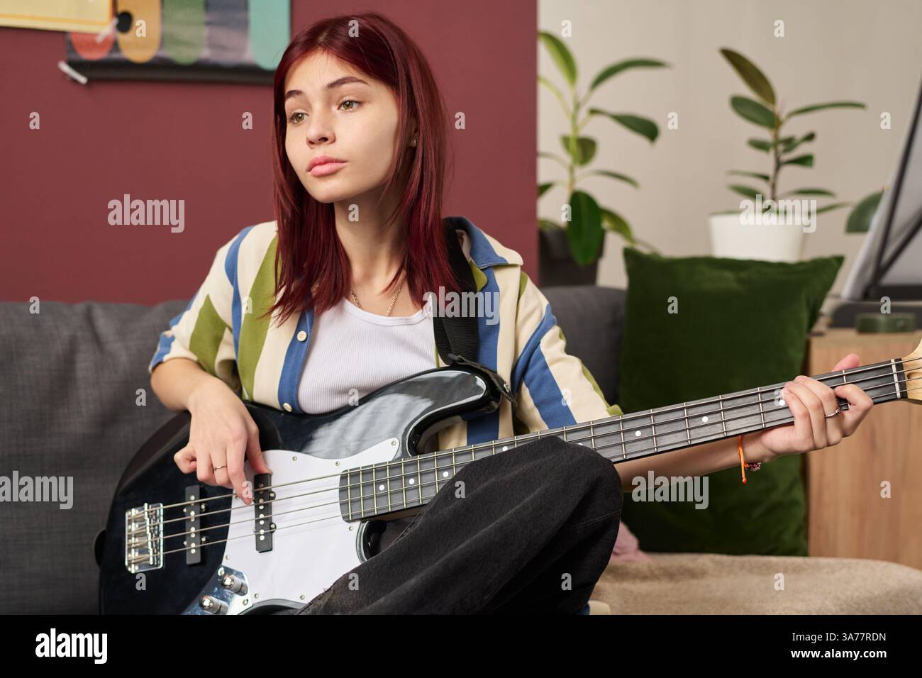 Teenage Girl Playing Electric Guitar on Couch Stock Photo - Alamy