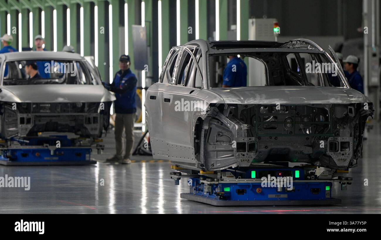 Employees work on the line during a media tour at the Hyundai Motor ...