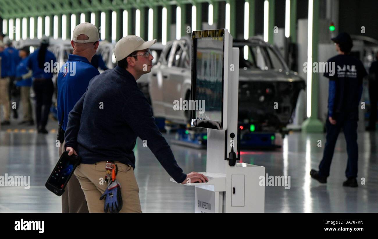 Employees work on the line during a media tour at the Hyundai Motor ...