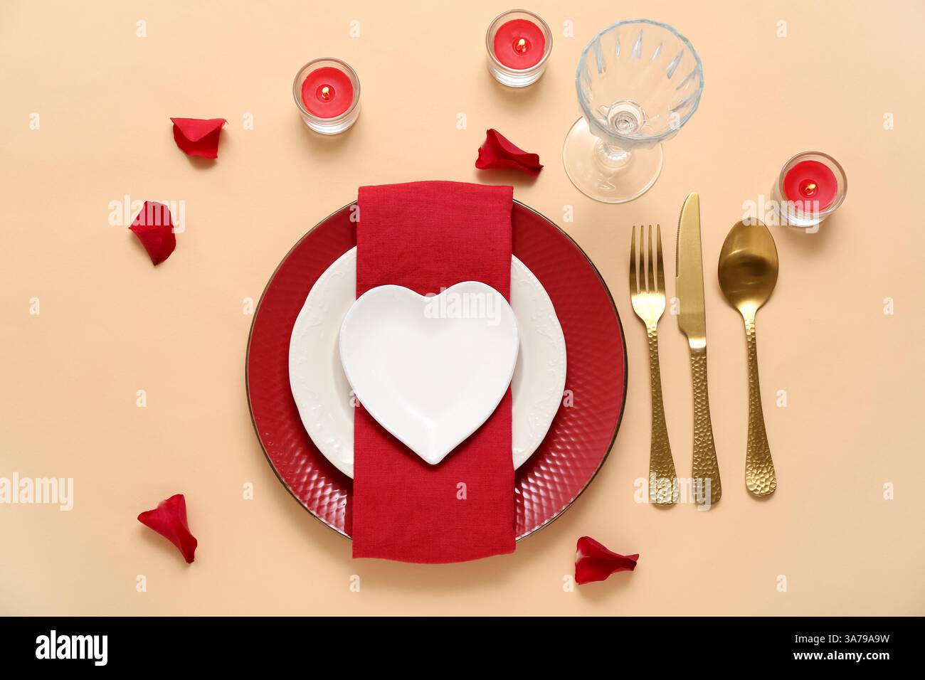 Beautiful table setting with burning candles and red rose petals on ...