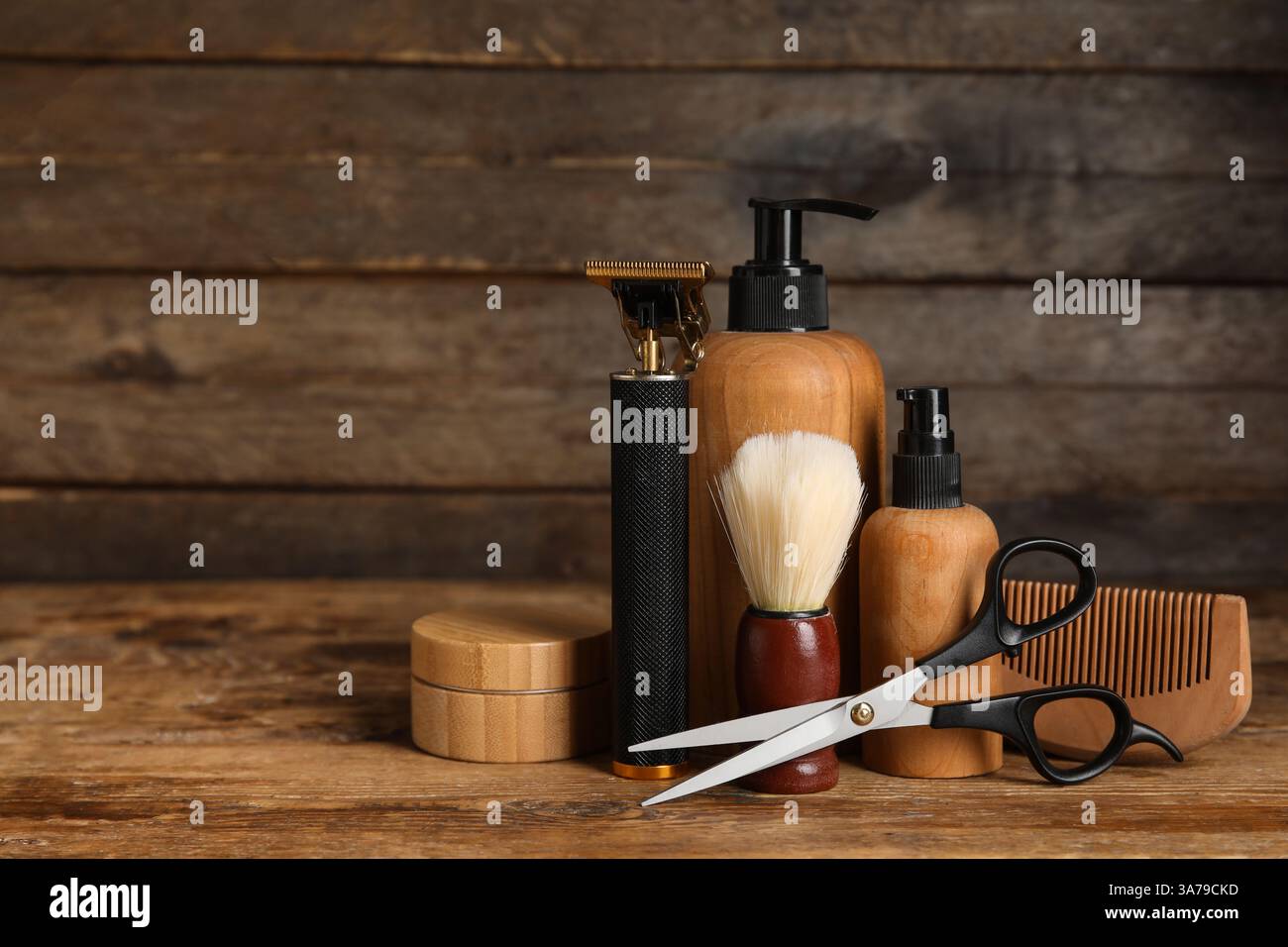 Shaving accessories with modern trimmer on wooden background Stock Photo