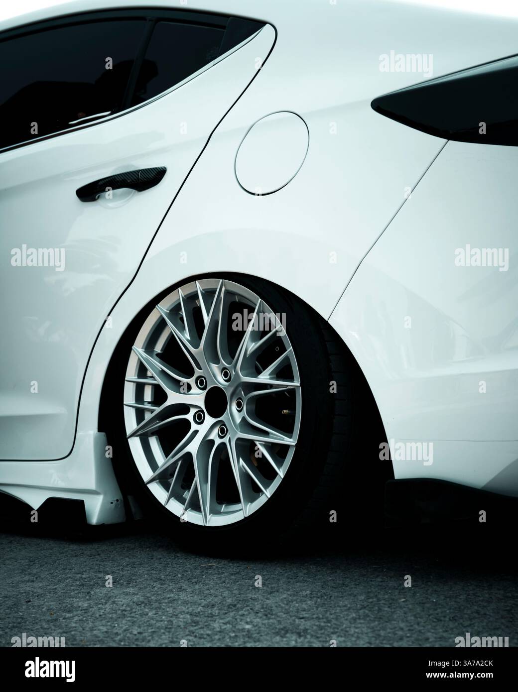 A stunning white luxury car with sleek silver alloy rims, isolated on a clean background. Perfect for showcasing high-end automotive design and luxury Stock Photo