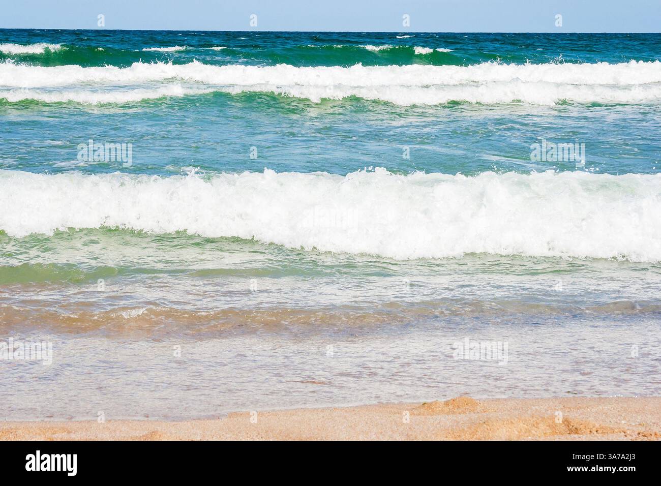 sea scenery in summer. public beach with golden sand. wonderful vacation background with transparent calm waves and blue sky. popular coast of bulgari Stock Photo