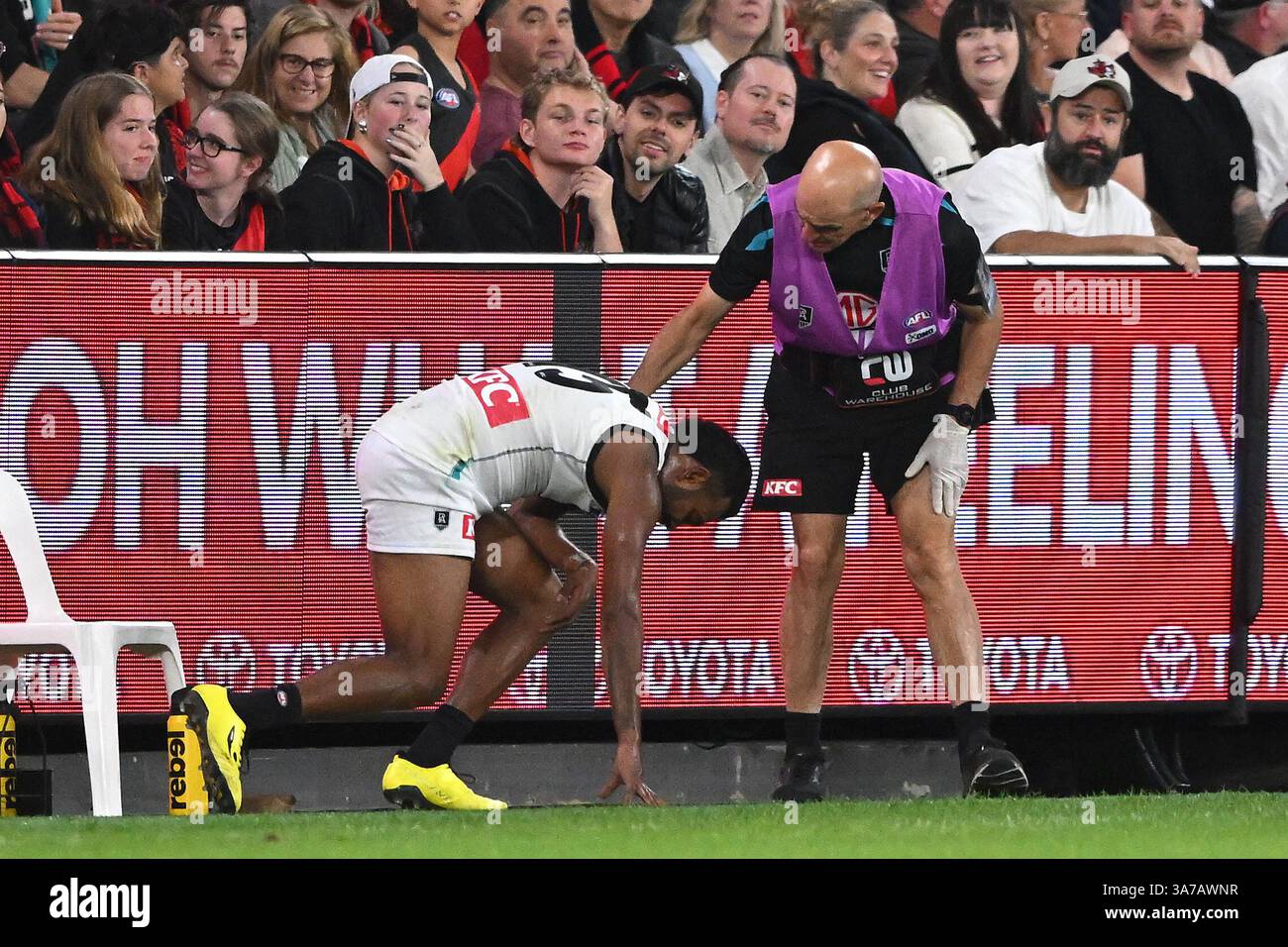Willie Rioli of Port Adelaide (left) after running into the fence ...