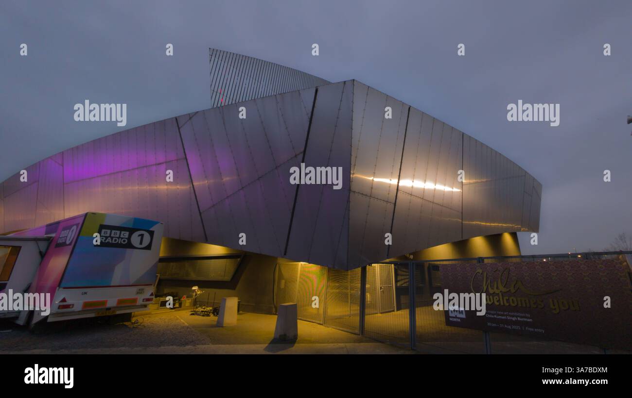 Imperial War Museum North with BBC Radio 1 mobile van.  Deconstructivist architecture. Salford Quays, Manchester UK - Smartphone Captured Stock Image