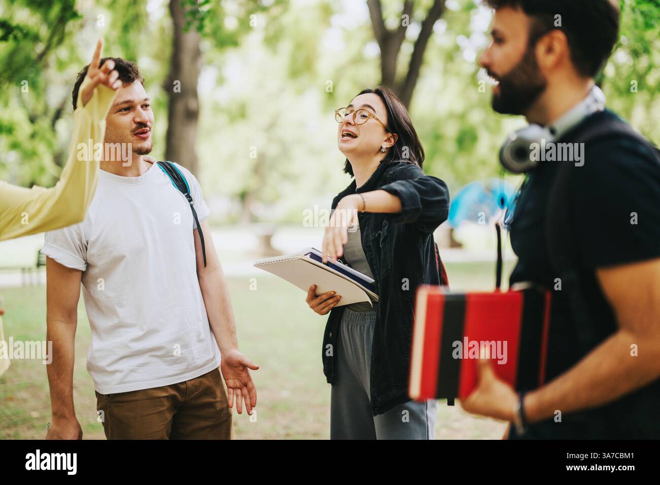 Multicultural students collaborating outdoors on school projects after classes Stock Photo