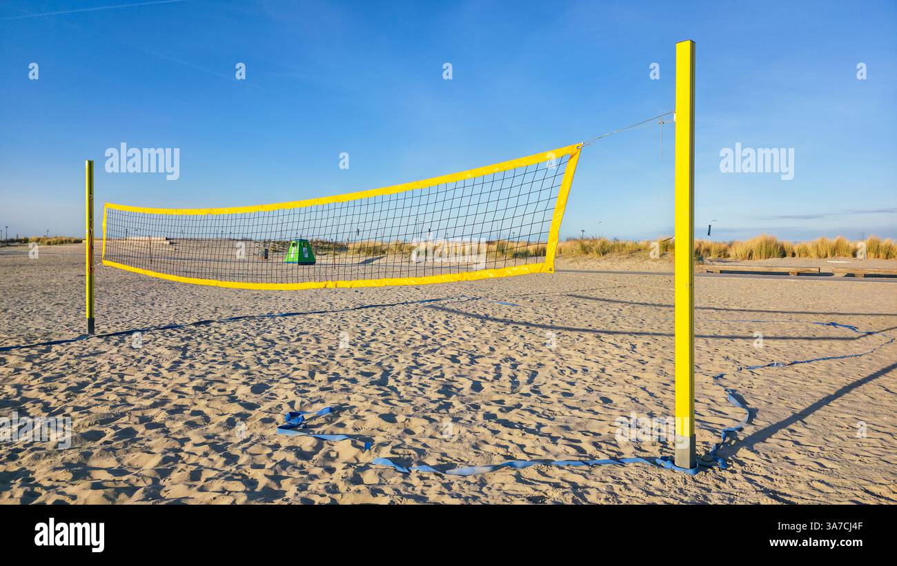 Beach volleyball net on sandy beach with blue sky - Smartphone Captured Stock Image