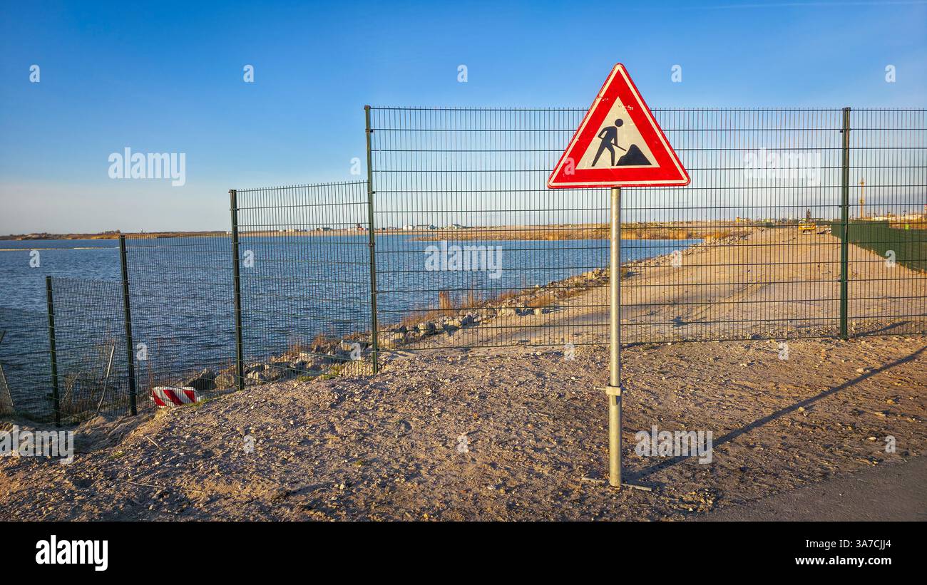 Works in progress warning sign on barren roadside - Smartphone Captured Stock Image