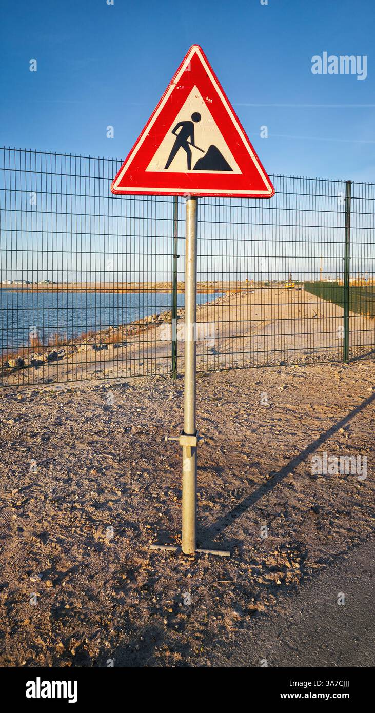 Works in progress warning sign on barren roadside - Smartphone Captured Stock Image