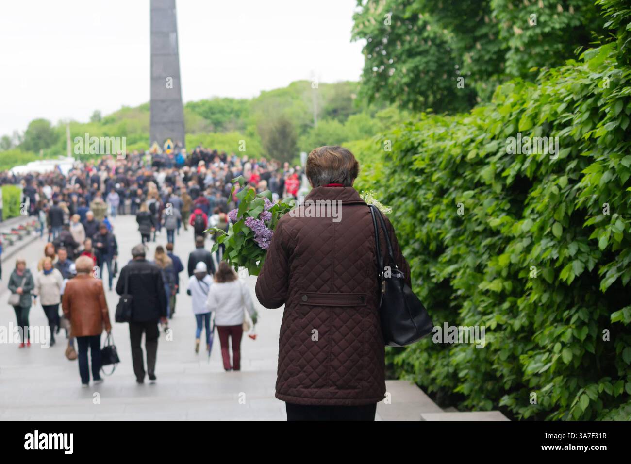 Kyiv, Ukraine - May 09, 2019: People carry flowers to the monument to ...