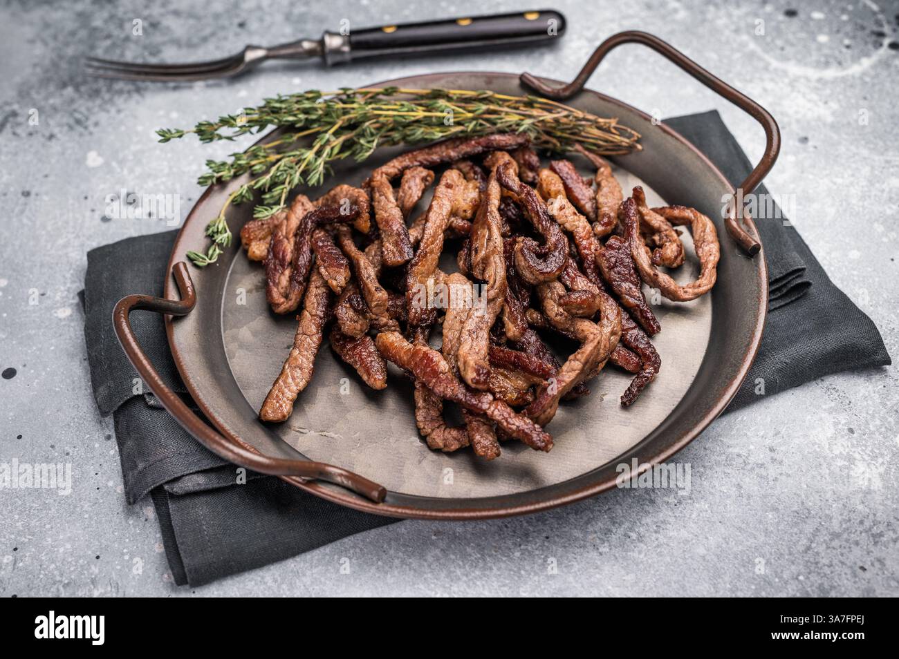 Deep Fly Meat Deep fried beef tender strips, sliced meat in a tray. grey background ...