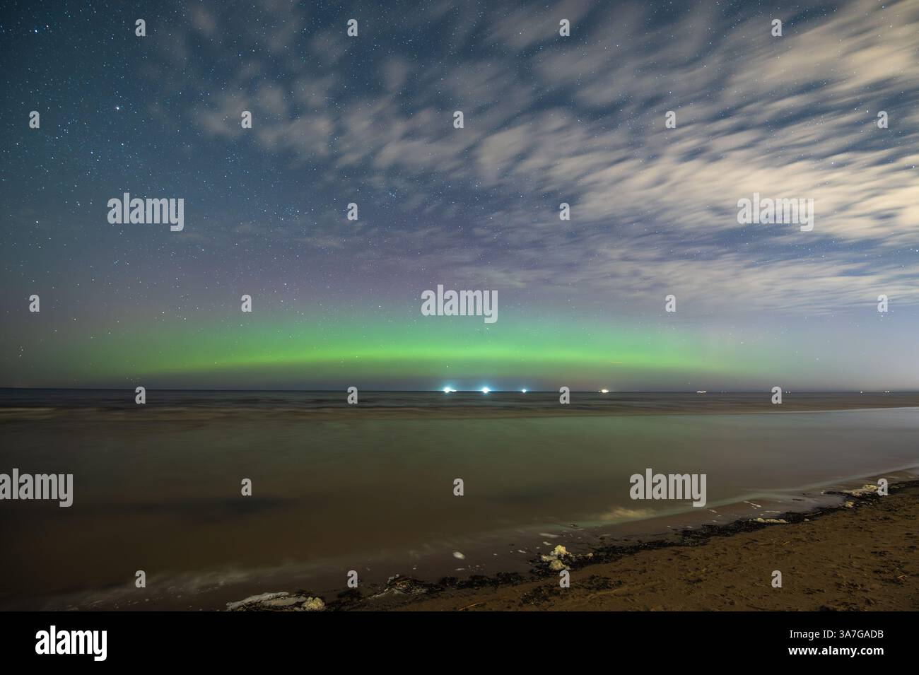 Aurora Borealis northen lights on the Baltic Sea beach in Latvia at ...