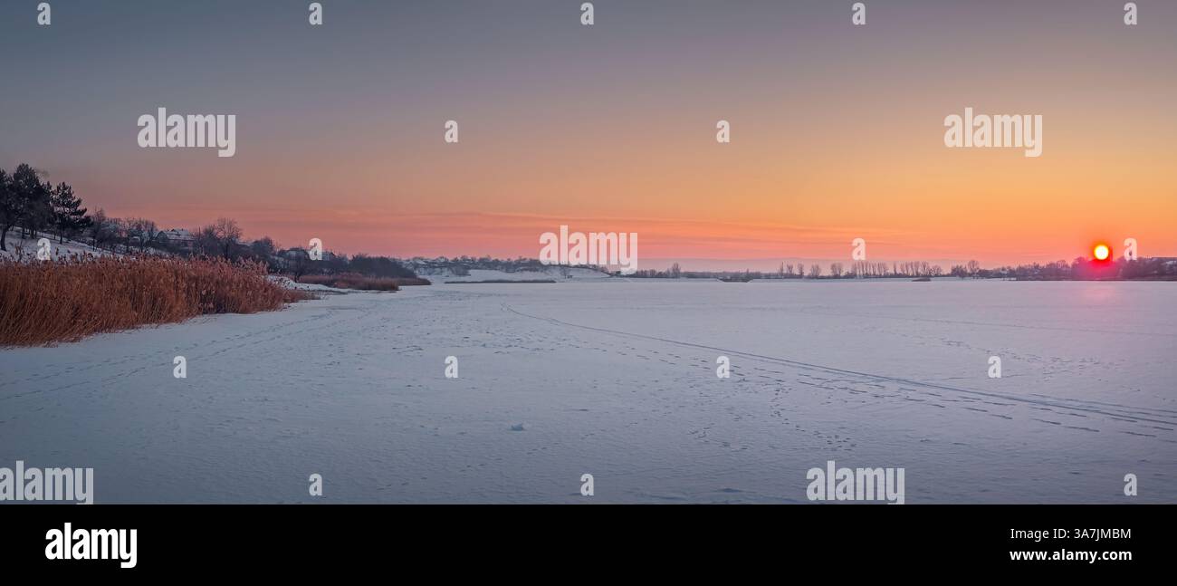 Winter panorama with a view to the frozen Delia lake covered with snow in Ungheni town, Moldova - Smartphone Captured Stock Image