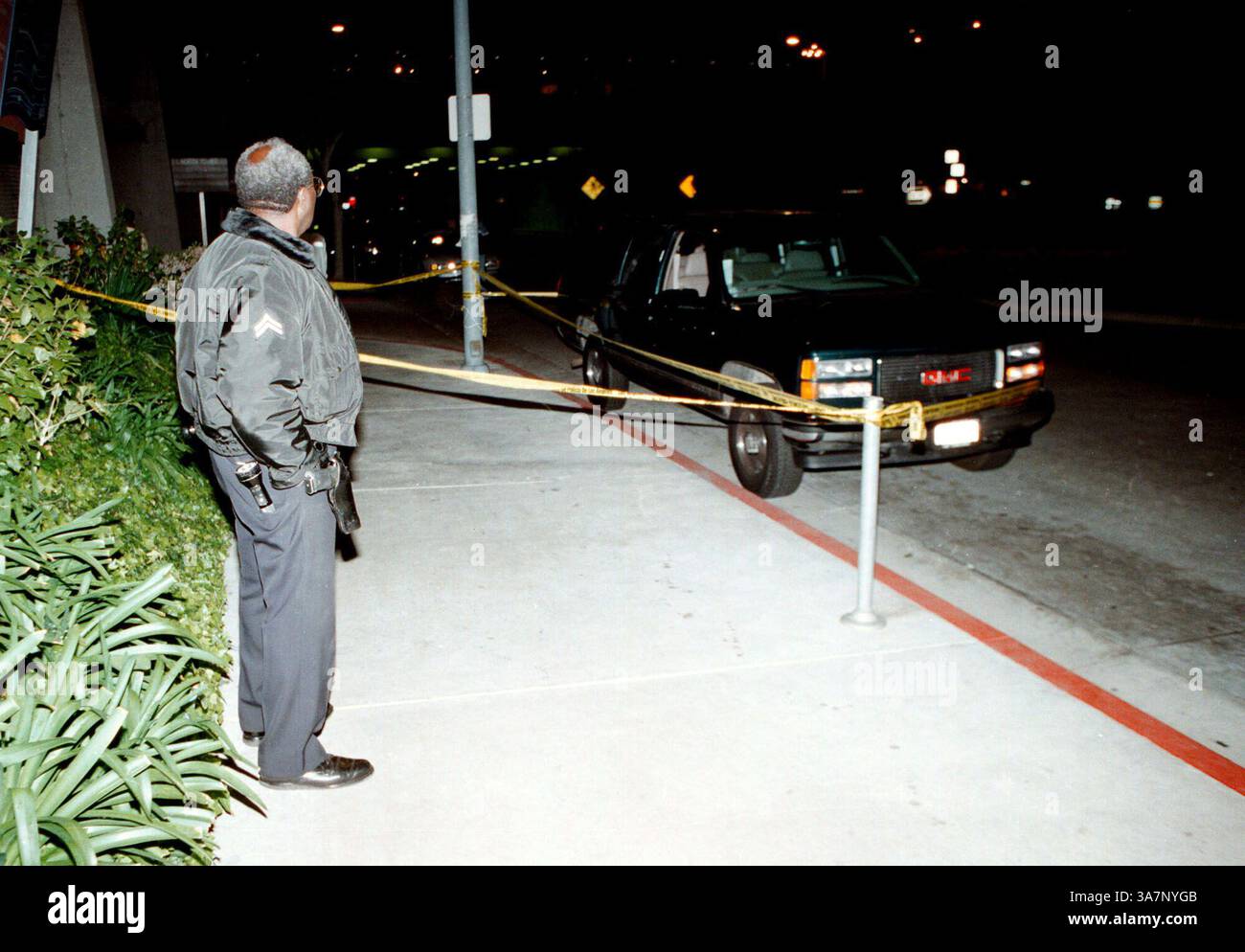 Dec. 7, 2012 - After 15 years, the Notorious B.I.G.'s autopsy report has been released. The autopsy report reveals Biggie's wounds and the fact that not all of his gunshot wounds were fatal. PICTURED: March 8, 1997 - Los Angeles, California, U.S. - Rapper Notorious B.I.G. murder. LAPD officer watches over the GMC Suburban, which the rapper Notorious B.I.G. was shot in. (Credit Image: © Mike Meadows/ZUMAPRESS.com) Stock Photo