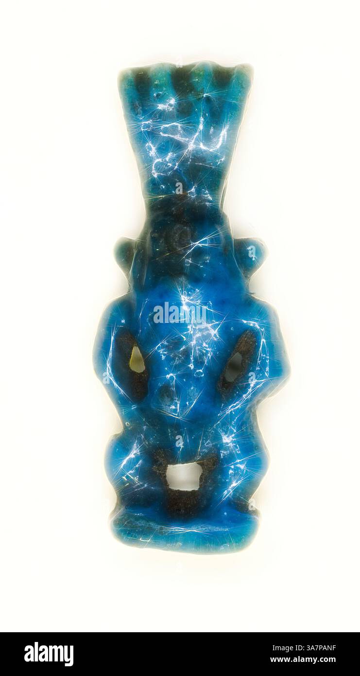 An intricately carved turquoise amulet shaped like a mythical creature ...