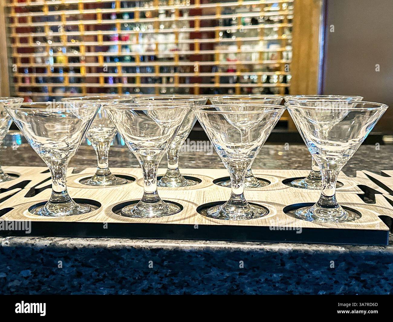 Row of empty martini cocktail glasses on the top of a bar. No people - Smartphone Captured Stock Image