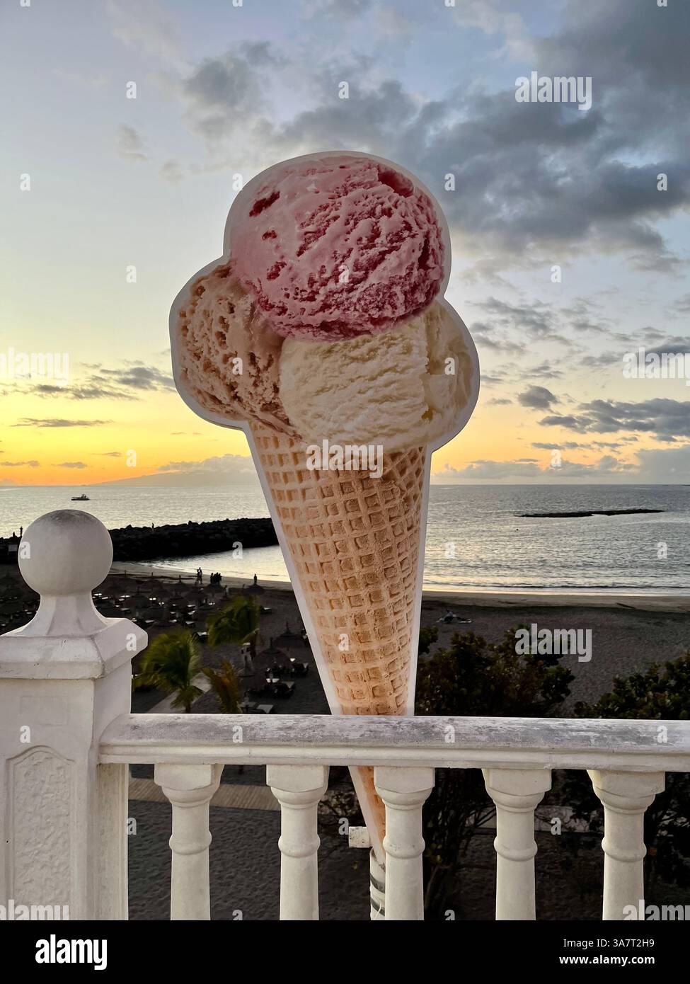 An Ice Cream Sign on the Costa Adeje Seafront Promenade, overlooking Playa de Torviscas. Concept: Holidays, Vacations, Sunset, Beach, Seaside. - Smartphone Captured Stock Image