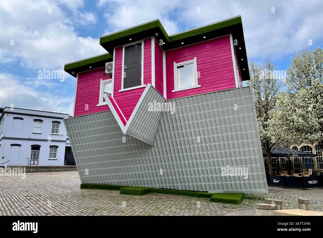 The Upside Down House in Anchor Square near Bristol Harbour. Bristol, England, United Kingdom. 26th March 2025. - Smartphone Captured Stock Image