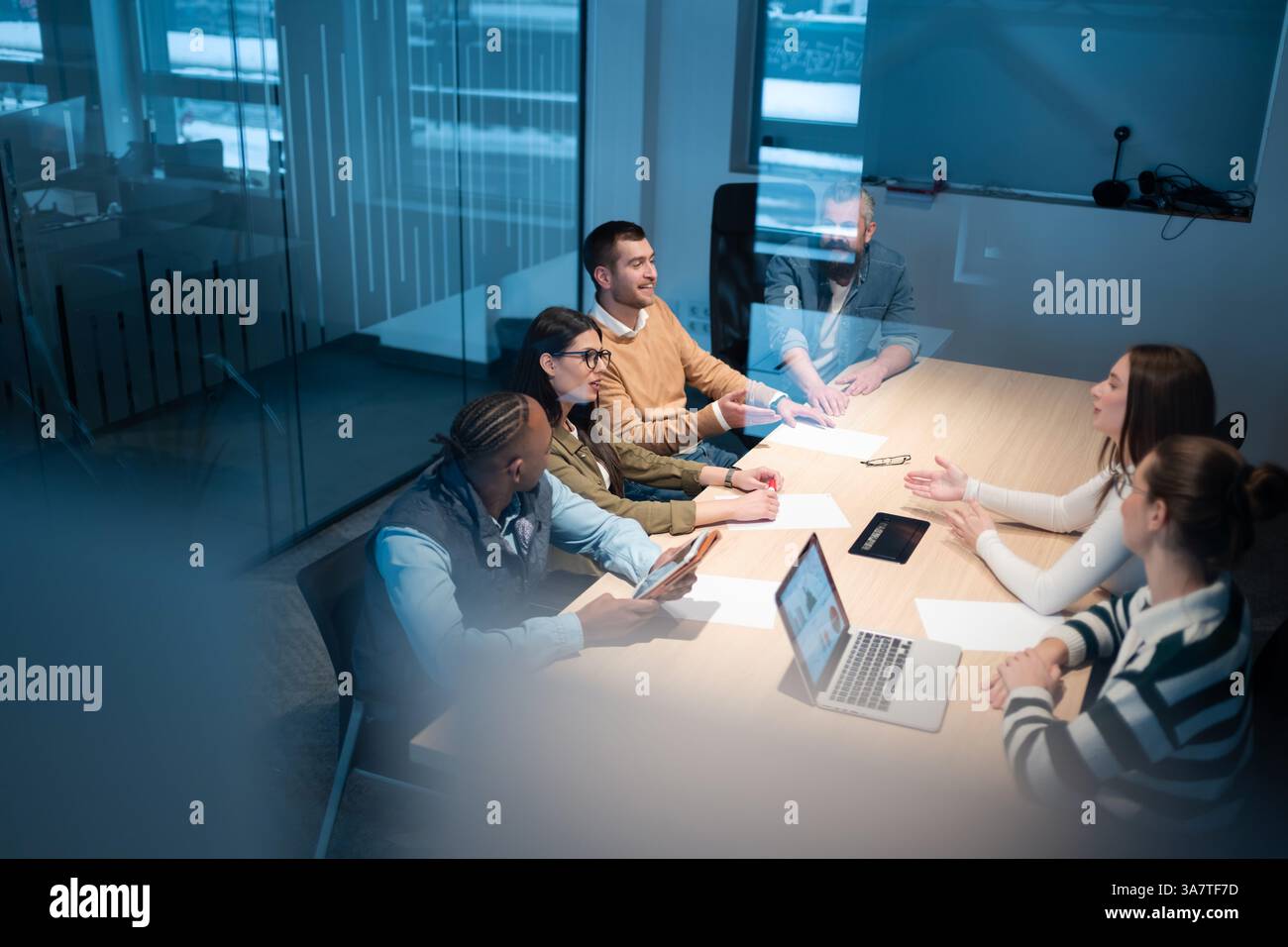 A diverse team of young professionals collaborates in a modern office ...