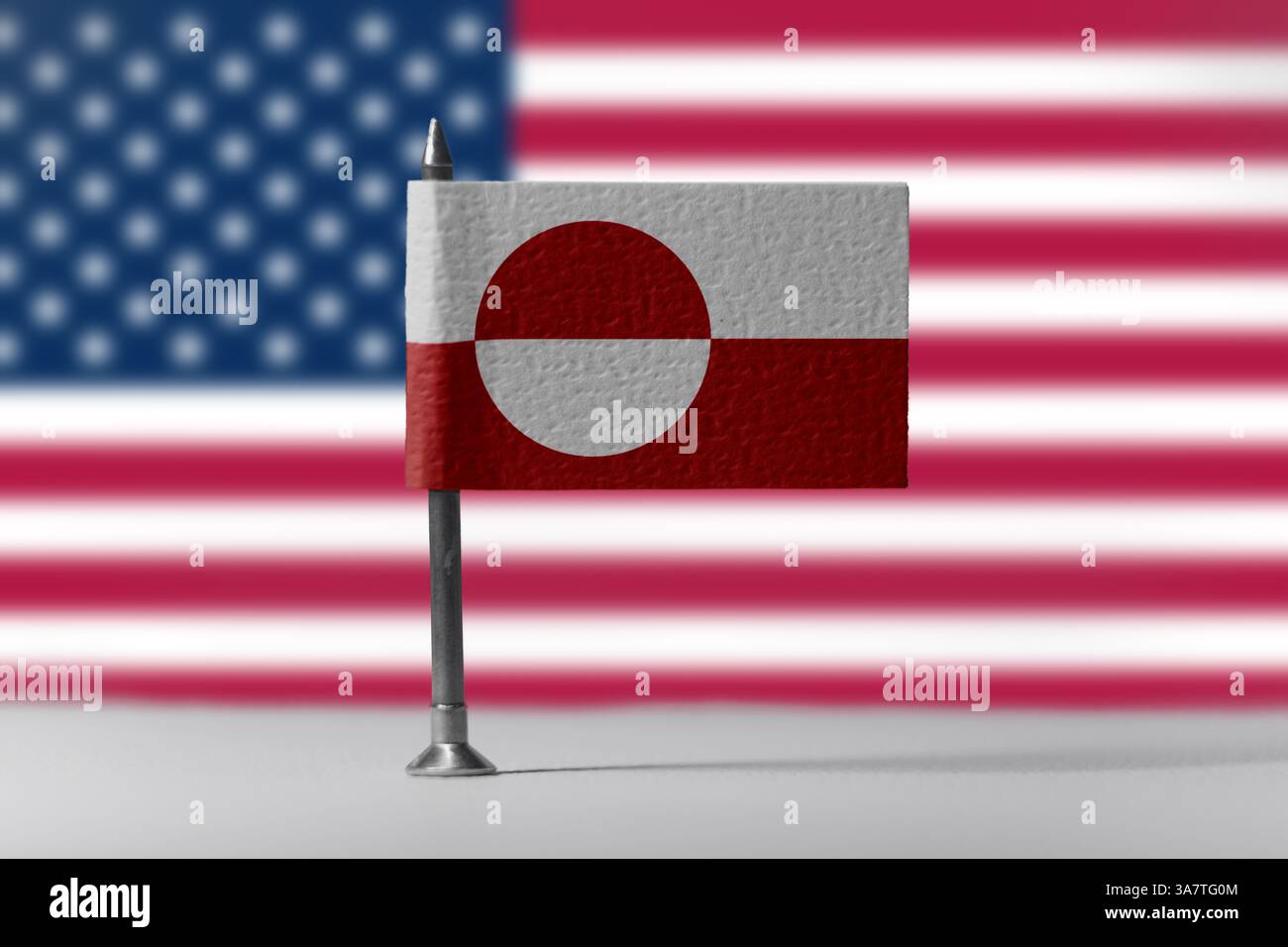 Greenland flag and USA flag in background. Concept of international relations, politics, and territorial interest in Arctic region. Stock Photo