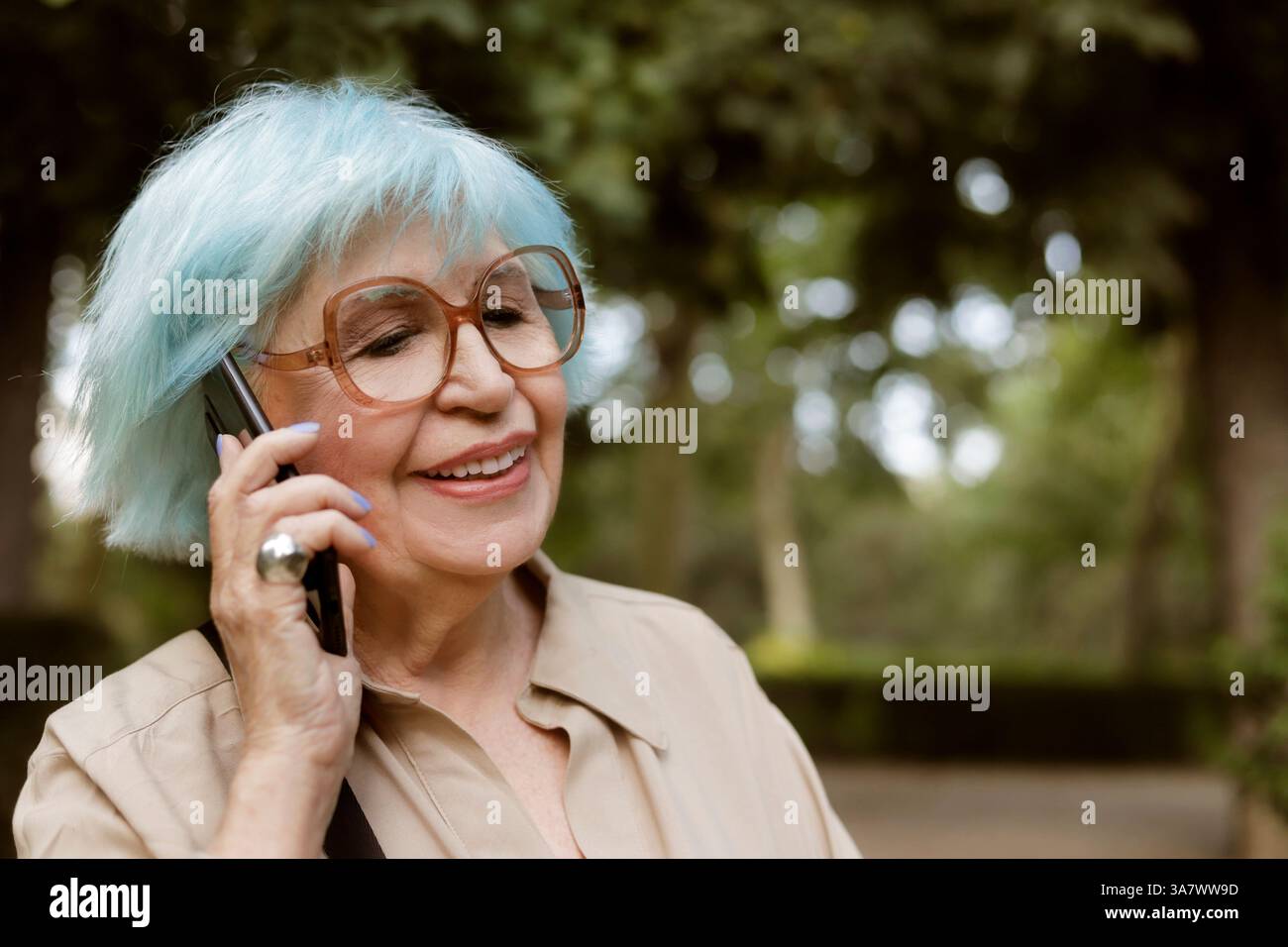 older woman outdoors talking on a cell phone Stock Photo