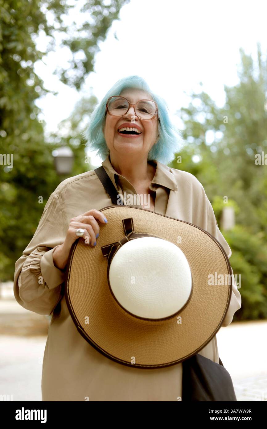 senior woman with blue hair very happy outdoors Stock Photo