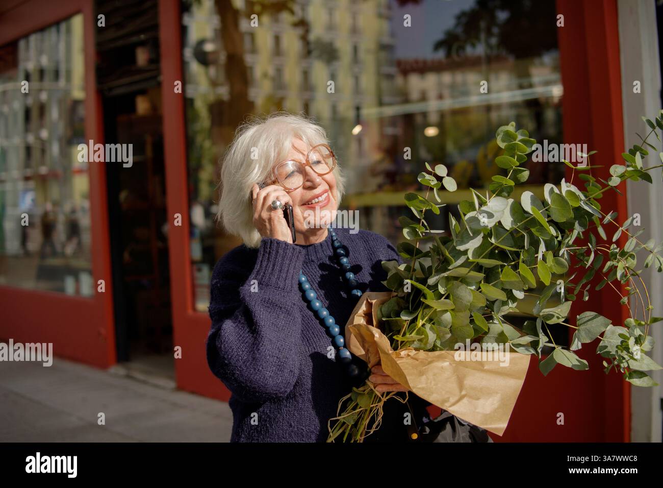 senior woman talking on cell phone outdoors Stock Photo