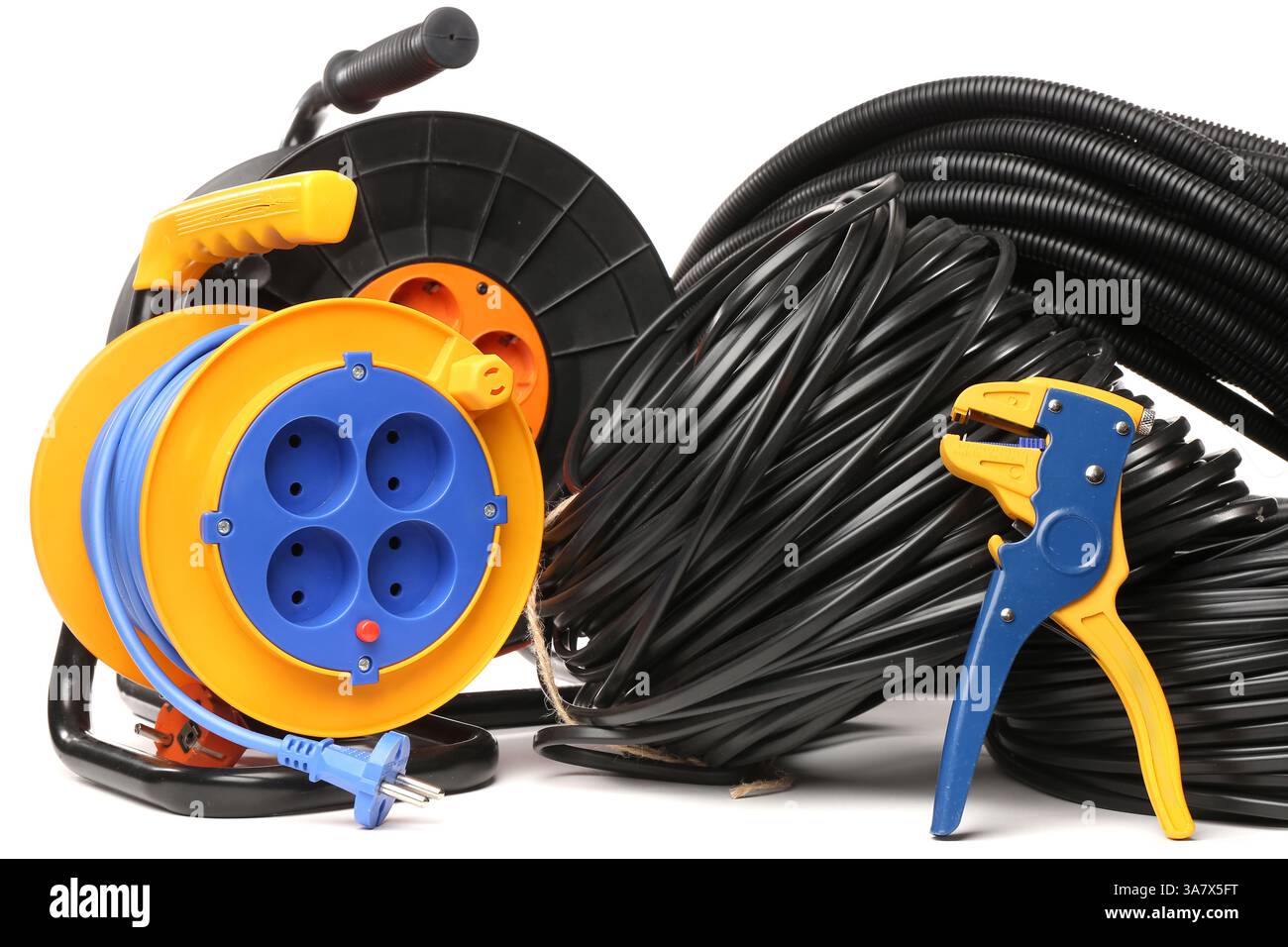 Wire stripper, rolled cables and extension cable reel on white background Stock Photo