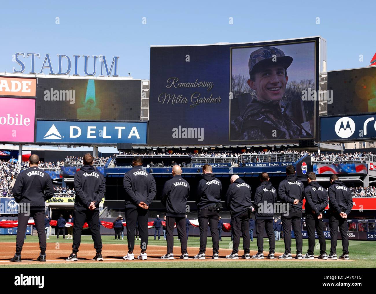 Bronx, United States. 27th Mar, 2025. Fans and players stand for a