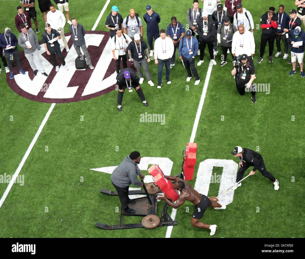 Texas A&M defensive lineman Nic Scourton runs a drill during the school ...