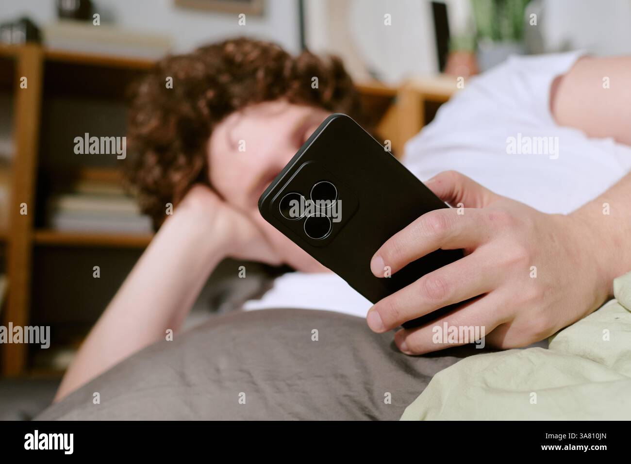 Relaxing on Couch While Holding Smartphone Stock Photo