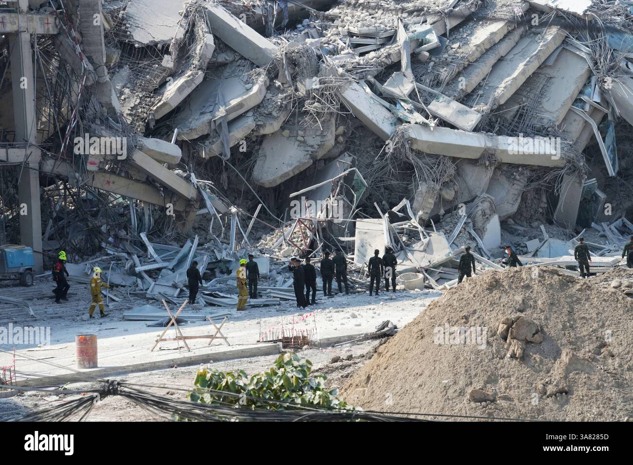 Rescuers work at the site of a high-rise building under construction ...