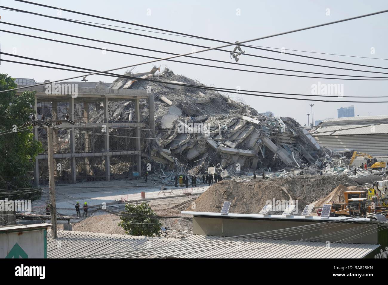 Rescuers work at the site of a high-rise building under construction ...