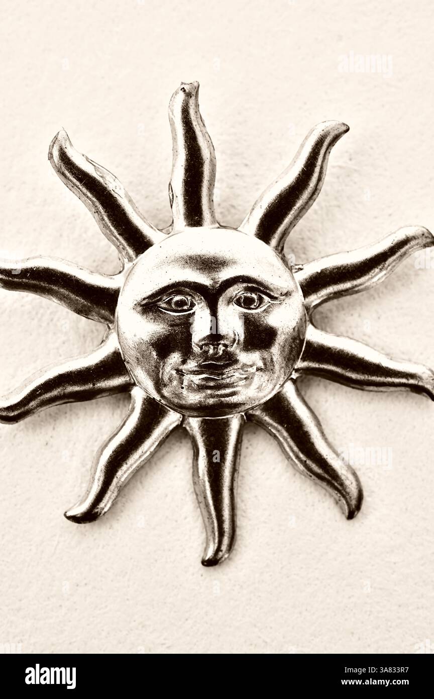 Sepia graphic image of rooch or ornament depicting sun face with long rays Stock Photo