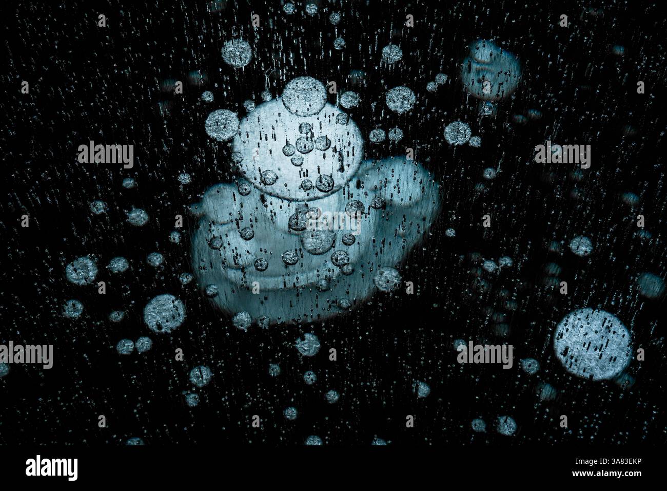 Ice bubbles under a frozen lake surface Stock Photo
