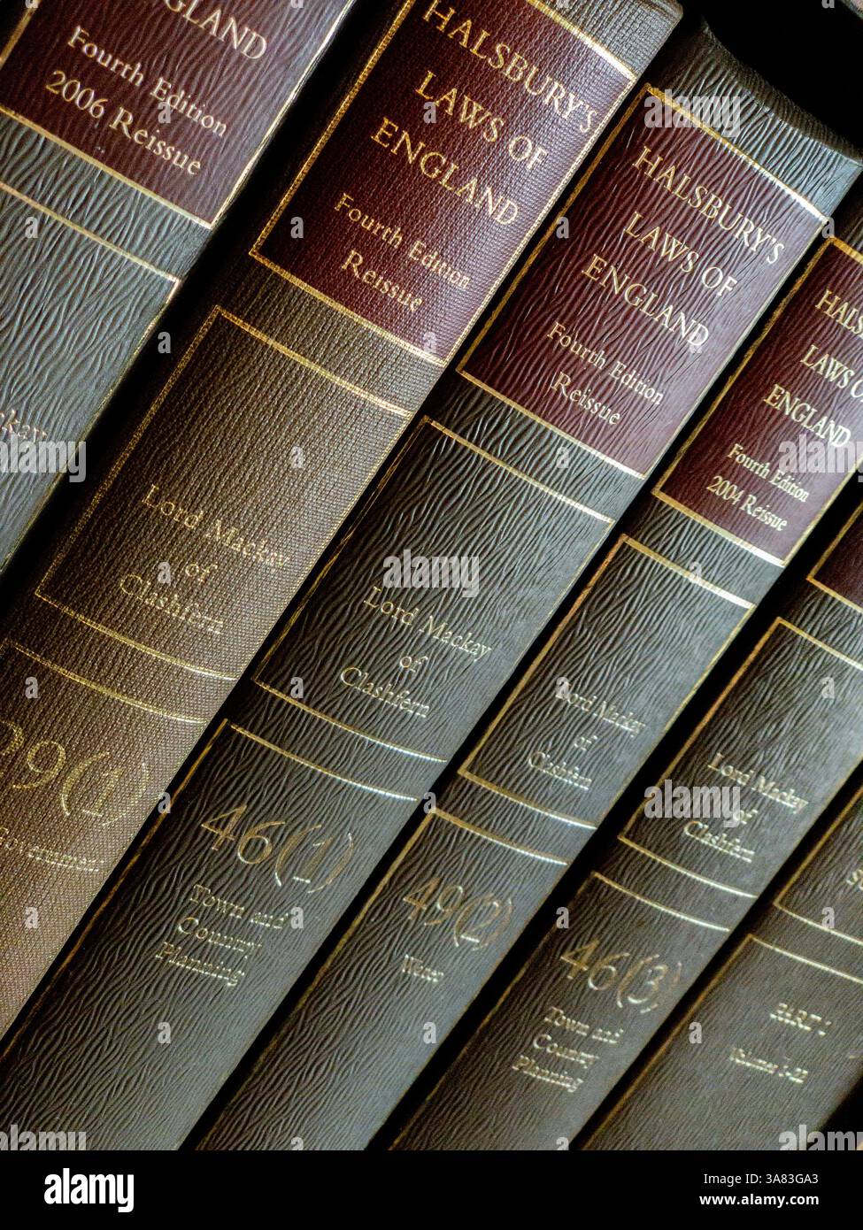 Close-up of the book spines of Halsbury’s Laws of England with its iconic red and gold bindings. UK. Stock Photo