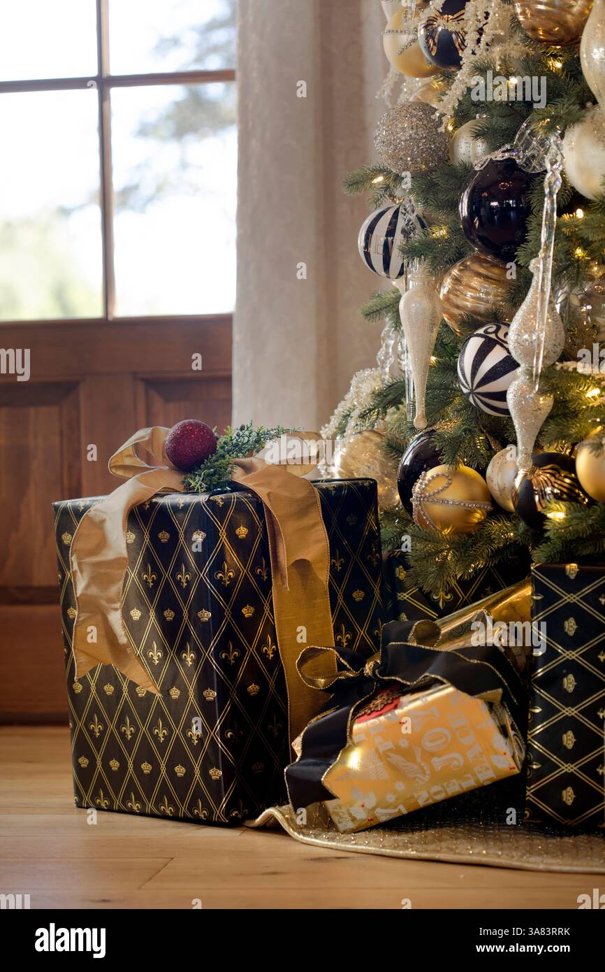 Gifts wrapped under a Christmas tree Stock Photo