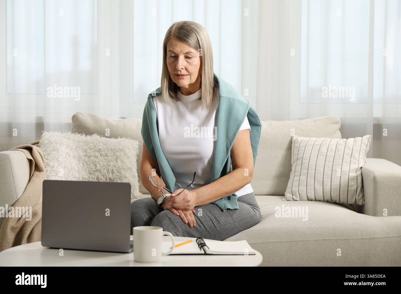 Woman learning online using laptop at table indoors. Self-study Stock Photo