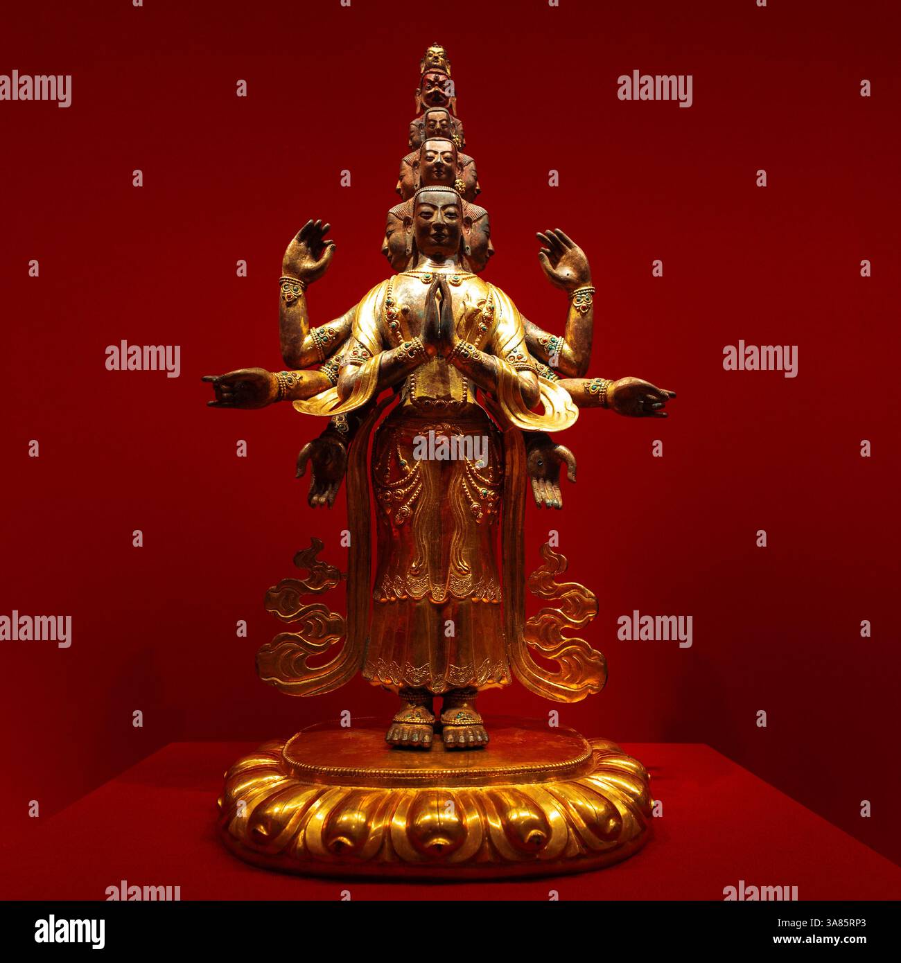 golden Avalokiteshvara Buddha statue with multiple arms and ornaments ...