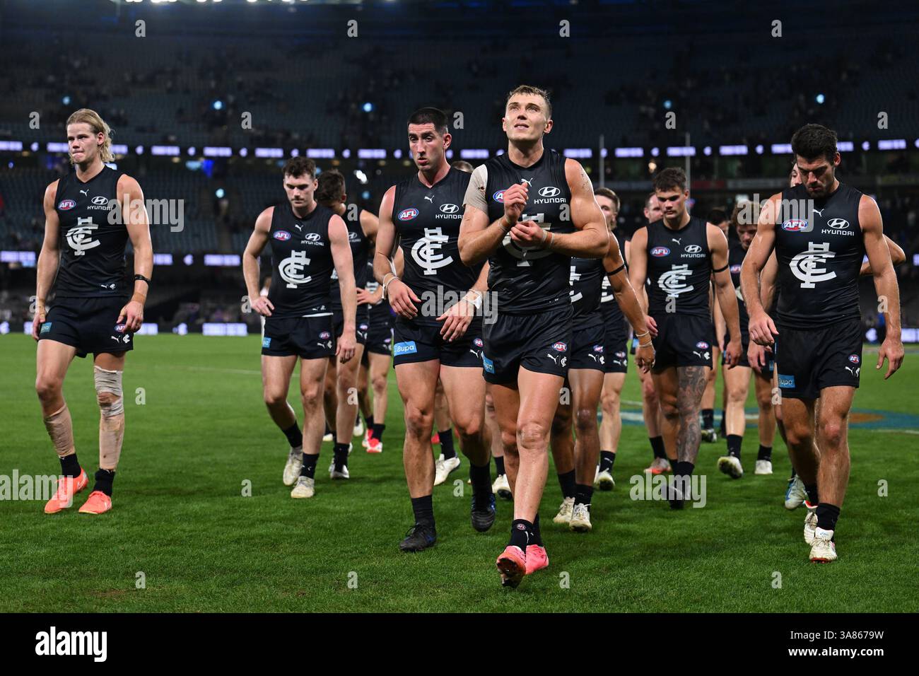 Patrick Cripps of Carlton (centre) leads the team off the field after ...