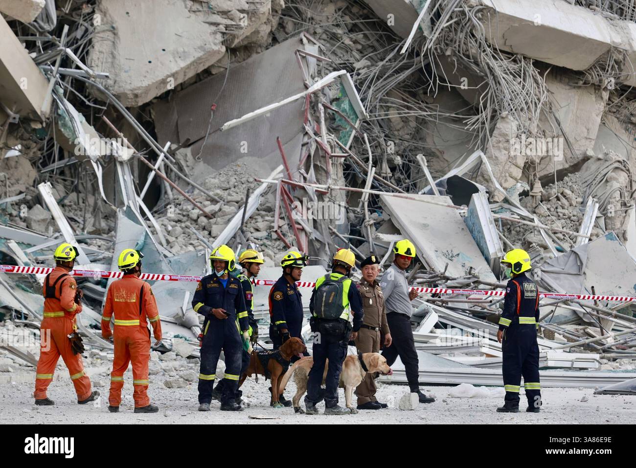 Rescuers work at the site a high-rise building under construction that ...