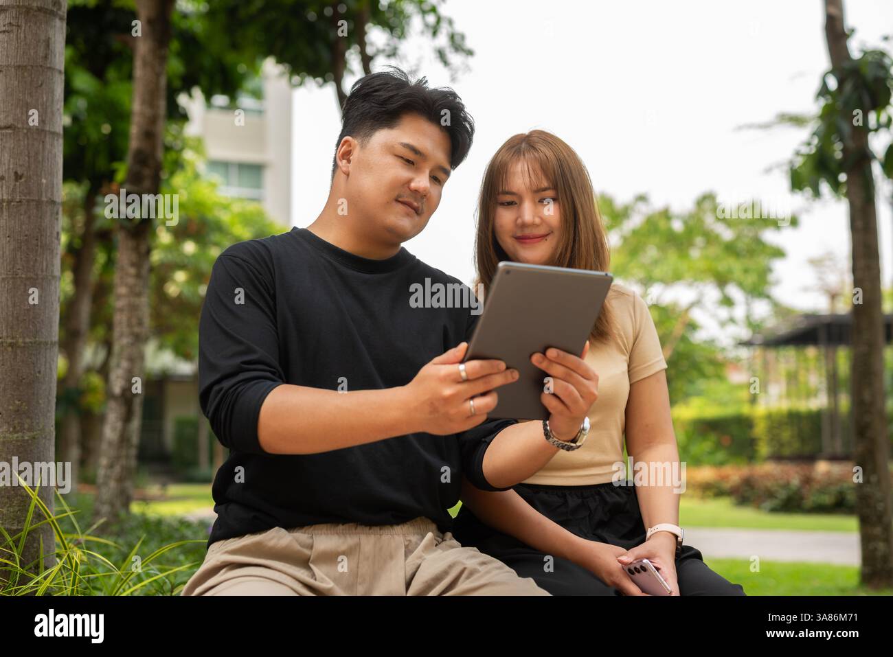Asian couple in park hi-res stock photography and images - Alamy