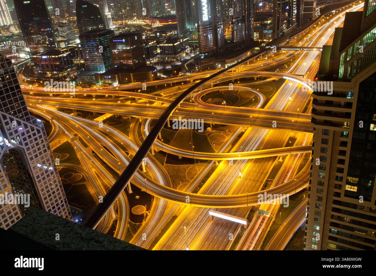 Night traffic on a busy intersection on Sheikh Zayed highway, Dubai, United Arab Emirates Stock Photo