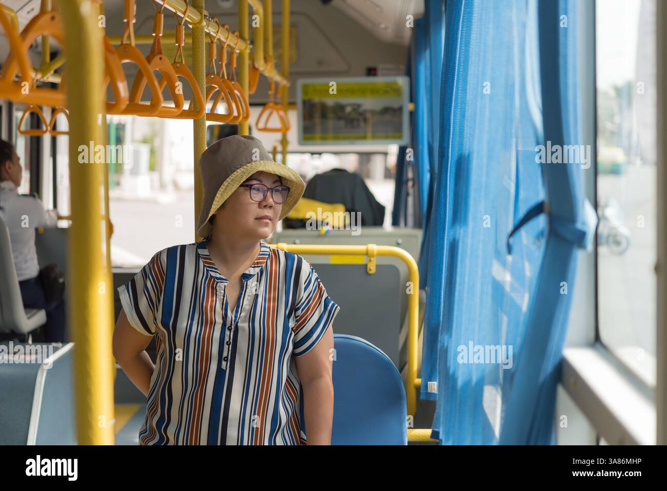 Asian woman 40s people travel by passenger bus in Bangkok city. Buses ...
