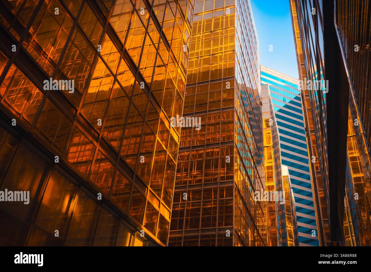 Gateway boulevard at harbour with golden buildings at sunset, Kowloon, Hong Kong, China Stock Photo