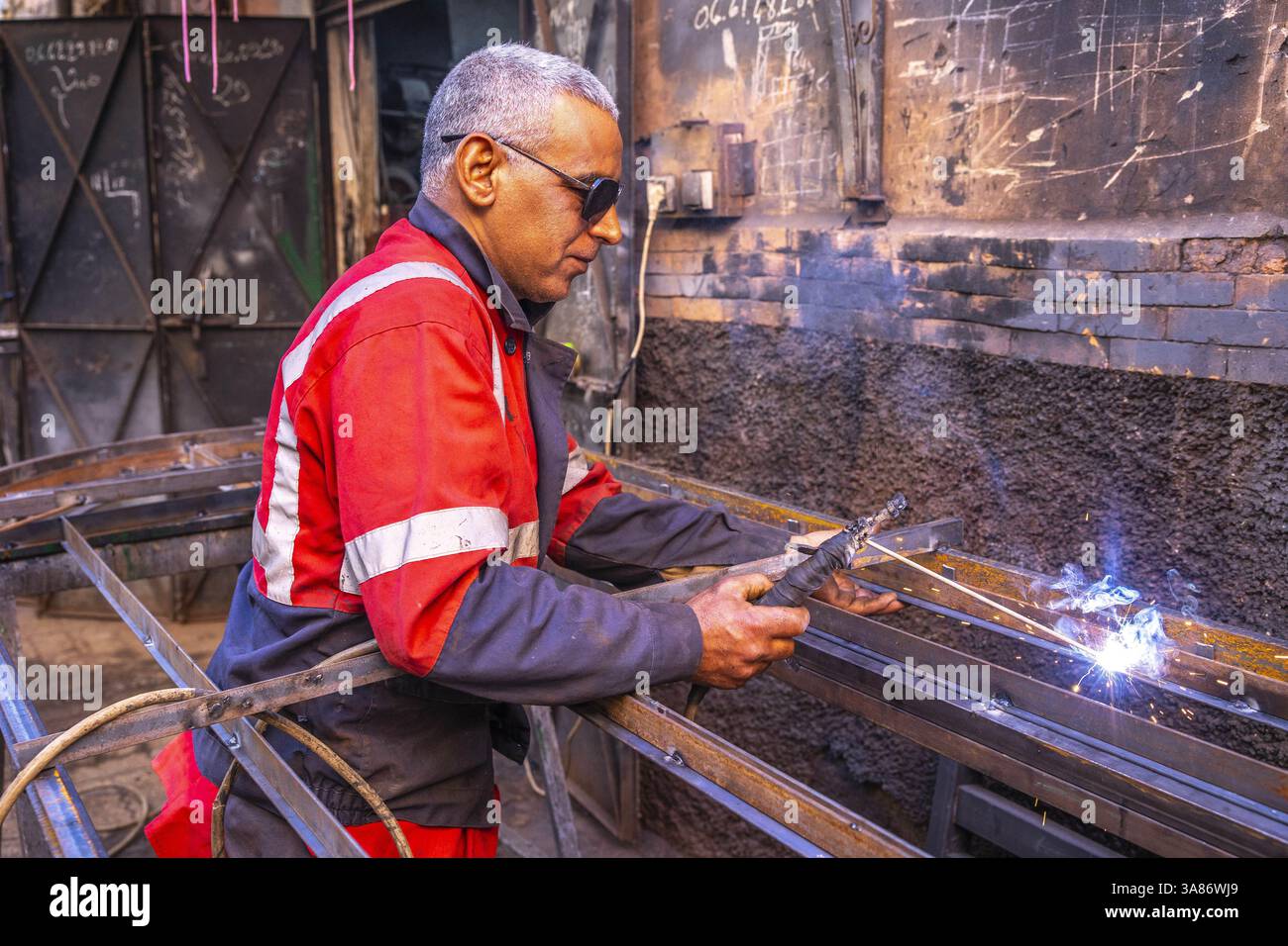 Welder at work in a workshop in Marrakesh, Morocco Stock Photo