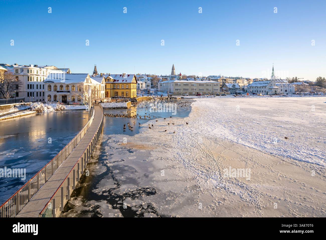 View of Tjornin lake and city skyline on a sunny day in winter, Reykjavik, Iceland Stock Photo