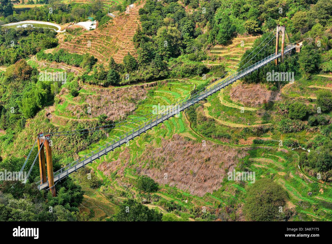 Suspension bridge over terrace farmland in Huangling, Wuyuan County, Shangrao City, Jiangxi Province, China Stock Photo