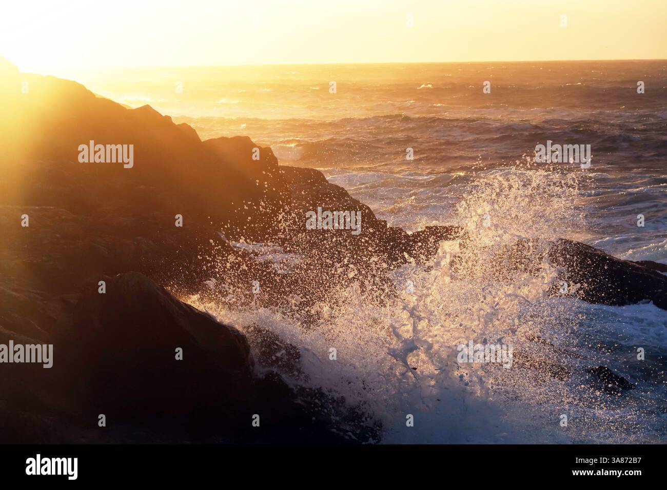 The Atlantic Ocean breaking on rocks at Boat Cove, West Penwith, Cornwall, England, United Kingdom Stock Photo
