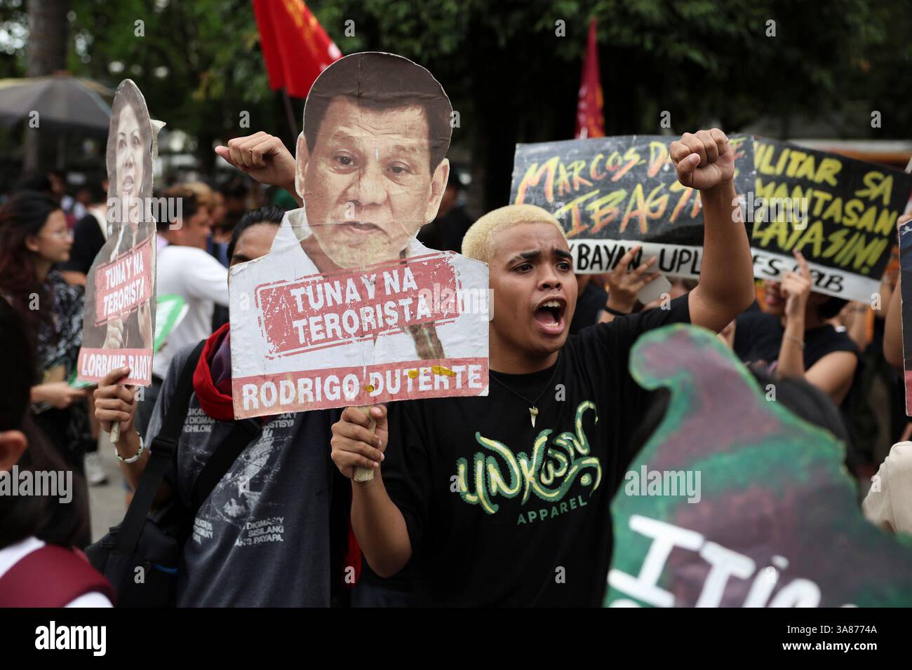 A man holds a sign against former Philippine President Rodrigo Duterte ...